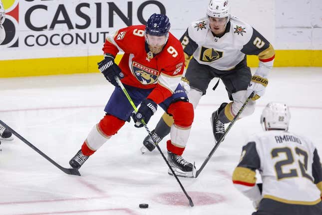 Mar 7, 2023; Sunrise, Florida, USA; Florida Panthers center Sam Bennett (9) moves the puck ahead of Vegas Golden Knights defenseman Zach Whitecloud (2) during the second period at FLA Live Arena.