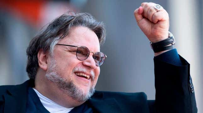 Guillermo del Toro cheering with his fist in the air.