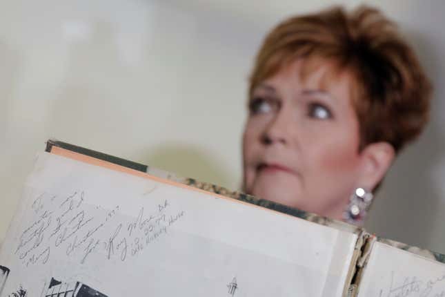 Beverly Young Nelson, who claimed that Alabama senate candidate Roy Moore sexually harassed her when she was 16, sits behind a signature by Roy Moore in her 1977 yearbook.