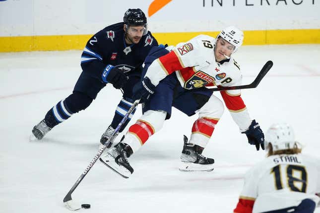 Dec 6, 2022; Winnipeg, Manitoba, CAN;  Florida Panthers forward Matthew Tkachuk (19) is checked by Winnipeg Jets defenseman Dylan DeMelo (2) during the third period at Canada Life Centre.