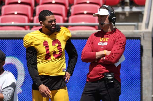 Apr 15, 2023; Los Angeles, CA, USA;  USC Trojans quarterback Caleb Williams (13) and head coach Lincoln Riley watch the game from the sideline during the Spring Game at Los Angeles Memorial Coliseum.