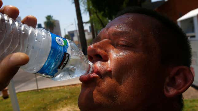 Steve Smith takes a drink of water as he tries to keep hydrated and stay cool as temperatures climb to near-record highs, in Phoenix in 2017.