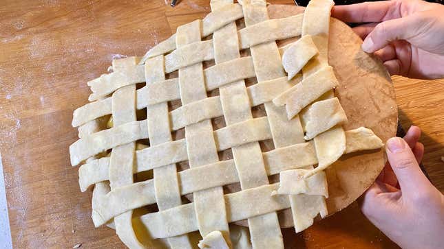 Lattice pie crust transferring to a pie.