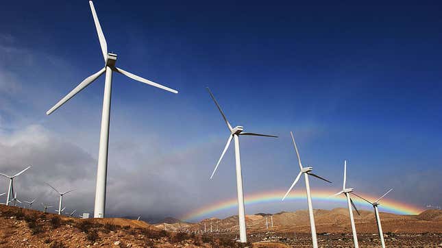 The first storm of the season produces a rainbow behind wind turbines in the San Gorgonio Pass November 9, 2002 near Palm Springs, California.