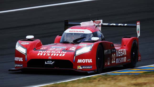 A photo of a red Nissan Le Mans racer on track. 