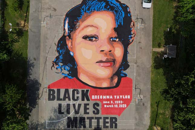 FILE - A ground mural depicting a portrait of Breonna Taylor is seen at Chambers Park in Annapolis, Md., July 6, 2020. The mural honors Taylor, a 26-year old Black woman who was fatally shot by police in her Louisville, Ky., apartment. A former Louisville police detective who helped write the warrant that led to the deadly police raid at Taylor’s apartment has pleaded guilty to a federal conspiracy charge.