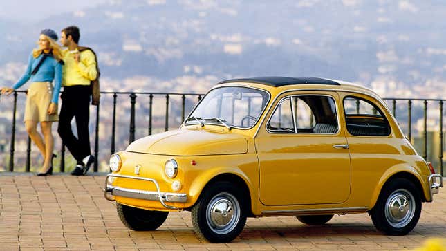 A photo of a vintage Yellow Fiat 500 car. 