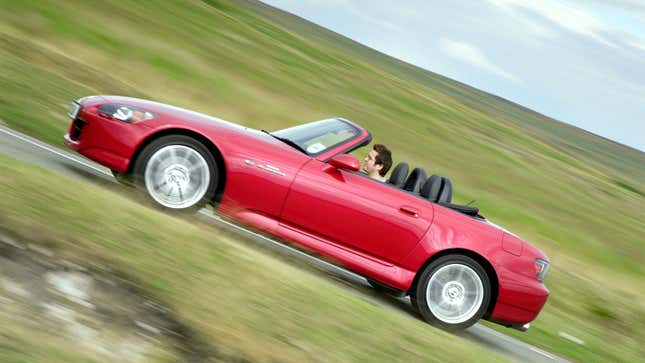 A photo of a convertible, red Honda S2000. 