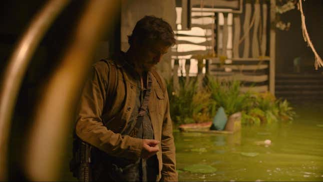 Pedro Pascal's Joel looks down at his hand in a scene from HBO's The Last of Us.