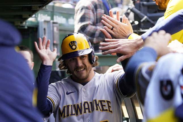 Apr 2, 2023; Chicago, Illinois, USA; Milwaukee Brewers third baseman Brian Anderson (9) is greeted in the dugout after scoring against the Chicago Cubs during the fourth inning at Wrigley Field.