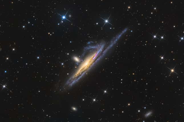 Two galaxies encroach on one another.