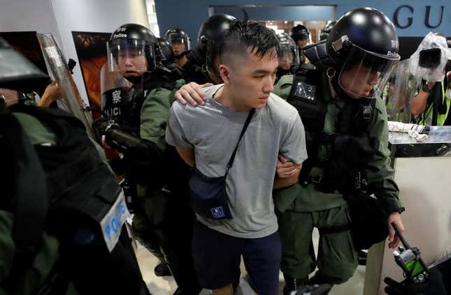 Riot police detain an activist after a march in Shatin’s New Town Plaza mall, Hong Kong, July 14, 2019.