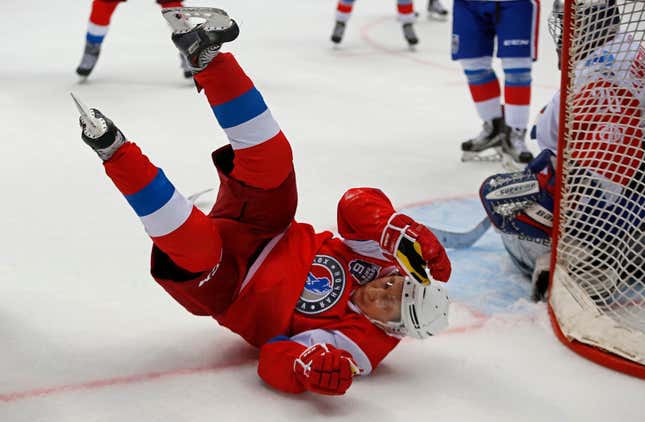 Russian President Vladimir Putin falls as he takes part in a gala match of the Night Hockey League teams in the Bolshoy Ice Arena.