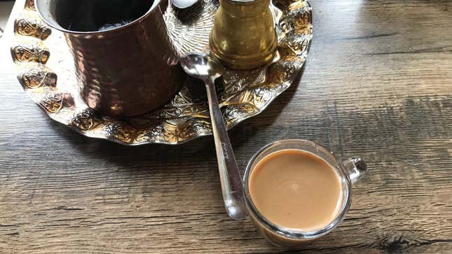 Turkish coffee beside decorative metal tray
