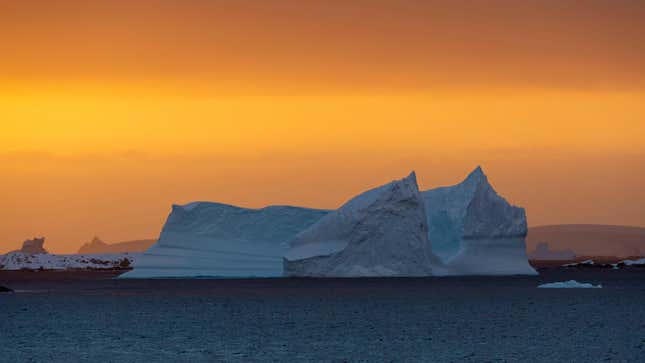 An Antarctic iceberg at sunset.