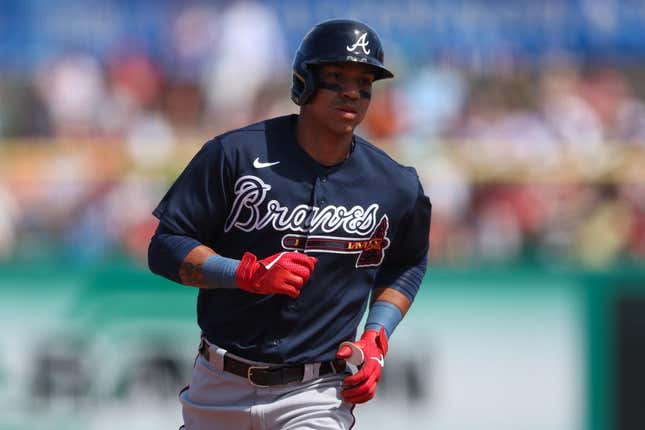 Mar 14, 2023; Clearwater, Florida, USA;  Atlanta Braves third baseman Ehire Adrianza (9) rounds the bases after hitting a grand slam home run against the Philadelphia Phillies in the fifth inning during spring training at BayCare Ballpark.