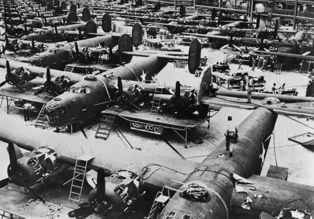 The fuselage and wing components for the Consolidated B-24 Liberator four-engined heavy bomber being assembled for service with United States Army Air Force (USAAF) at the Ford Motor Company Willow Run B-24 Liberty Bomber aircraft assembly plant on circa December 1942 in in Detroit, Michigan, United States. 