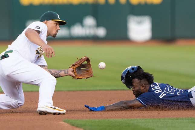Jun 14, 2023; Oakland, California, USA;  Tampa Bay Rays left fielder Randy Arozarena (56) attempts to beat the ball during the fourth inning against the Oakland Athletics third baseman Jace Peterson (6) at Oakland-Alameda County Coliseum.