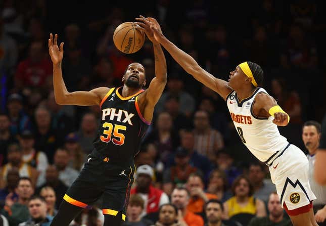 Apr 6, 2023; Phoenix, Arizona, USA; Phoenix Suns forward Kevin Durant (35) grabs a loose ball against Denver Nuggets forward Peyton Watson (8) in the first half at Footprint Center.