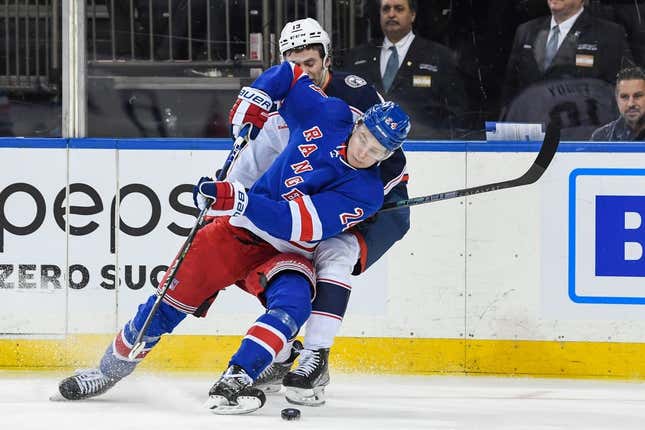 Mar 28, 2023; New York, New York, USA;  Columbus Blue Jackets center Liam Foudy (19) and New York Rangers right wing Kaapo Kakko (24) battle for the puck during the first period at Madison Square Garden.