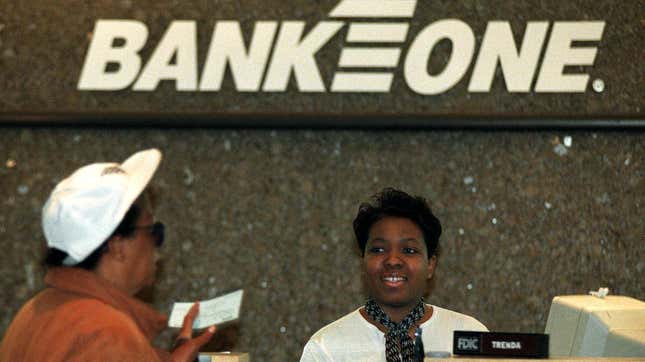 A customer talks to a teller at a Bank One office in Ohio, 1998