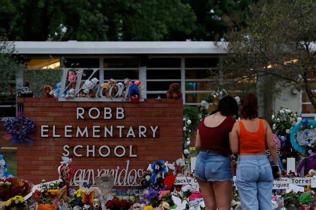 A general view as people mourn outside a memorial to honor the victims killed in last month’s school shooting outside Robb Elementary School in Uvalde, Texas.