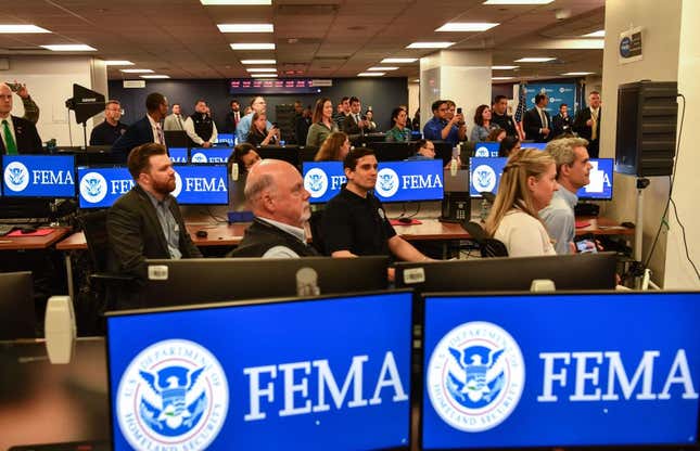 Members of FEMA look on as US President Joe Biden speaks during a briefing on the upcoming Atlantic hurricane season at FEMA headquarters on May 24, 2021, in Washington, DC.