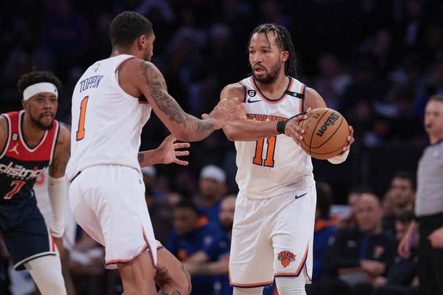 Apr 2, 2023; New York, New York, USA; New York Knicks guard Jalen Brunson (11) sets the ball for forward Obi Toppin (1) in front of Washington Wizards guard Jordan Goodwin (7) during the second half at Madison Square Garden.