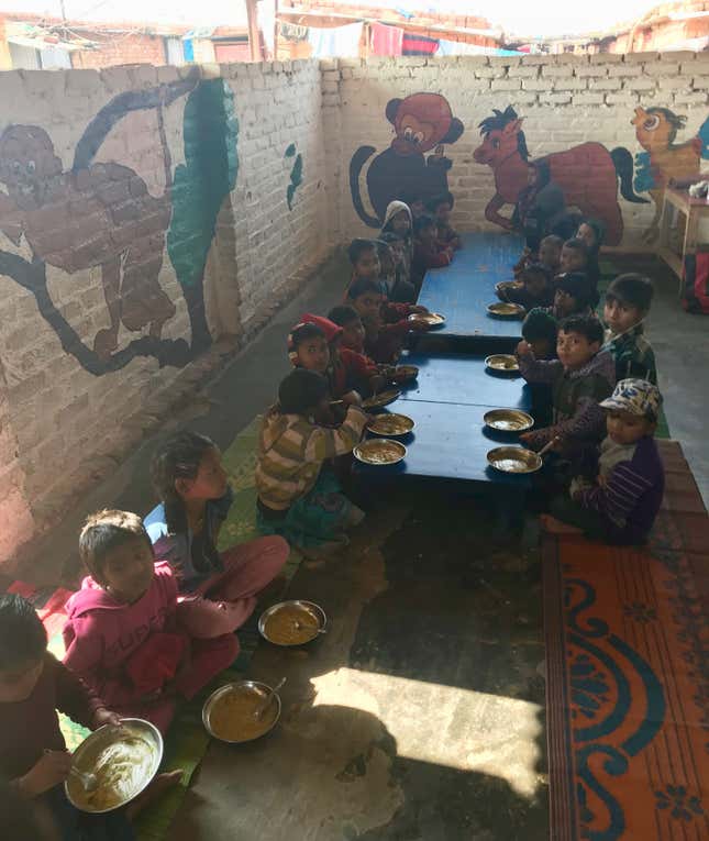 Kids eat lunch at the Sector 68 mobile creche