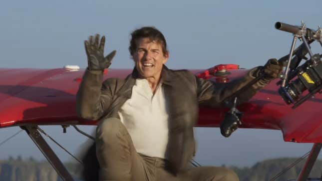 Tom Cruise waving hello in the sky on a little red plane