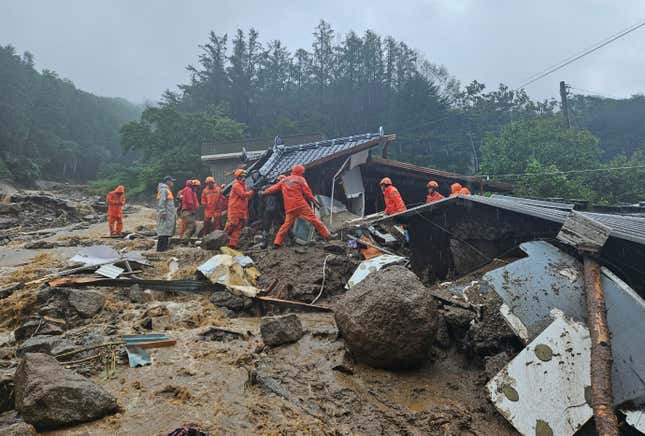 Rescue workers search for people in a house collapsed after a landslide caused by heavy rain in Yeongju, South Korea, on July 15, 2023.