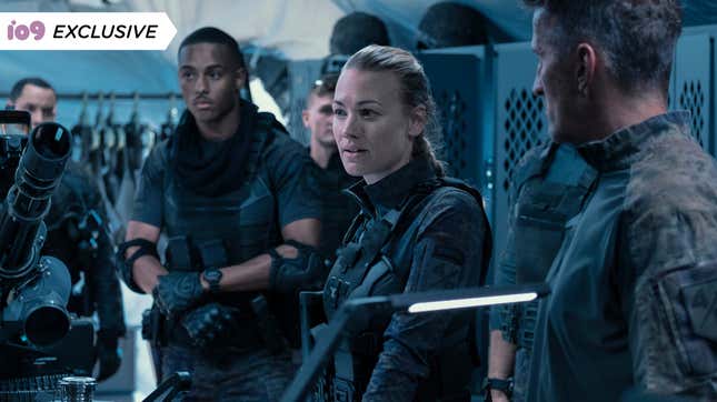 A scientist from the future (Yvonne Strahovski) stands surrounded by soldiers in a scene from sci-fi action movie The Tomorrow War.