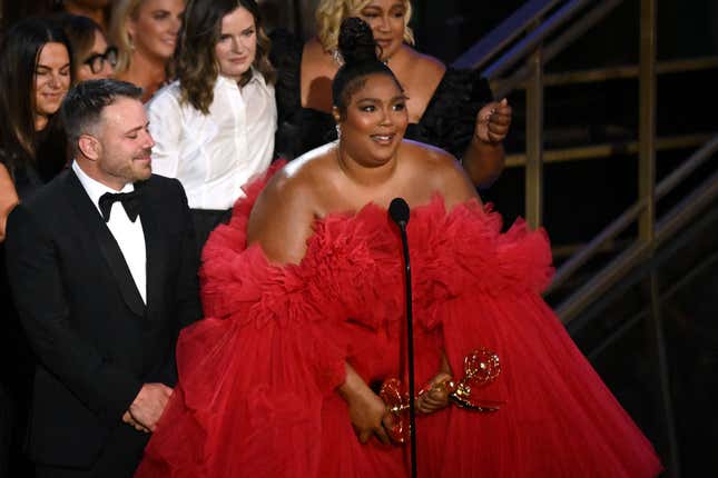 Lizzo (R) accepts the award for Outstanding Competition Program for “Lizzo’s Watch Out For the Big Grrrls” onstage during the 74th Emmy Awards at the Microsoft Theater in Los Angeles, California, on September 12, 2022. (Photo by Patrick T. FALLON / AFP) (Photo by PATRICK T. FALLON/AFP via Getty Images)