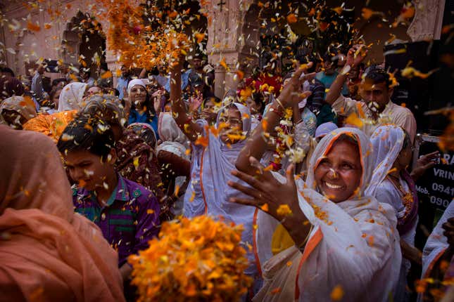 Hindu widows throw flower petals during Holi celebrations at the Gopinath temple in Vrindavan, south-east of New Delhi, India, March 9. (AP Photo/Manish Swarup)