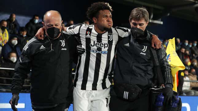 USMNT Midfielder Wes McKennie is helped off the pitch after injuring his foot playing for Juventus in February.