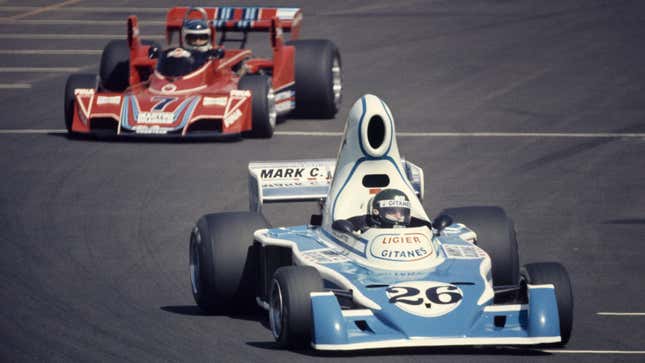 A photo of a 1976 Ligier Formula 1 car racing on track. 