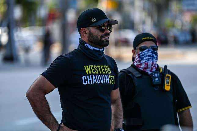 Chairman of the Proud Boys Enrique Tarrio (L), wearing a shirt supporting Derek Chauvin, looks on while counter-protesting near the Torch of Friendship, where people gathered to remember George Floyd on the one-year anniversary of his death at the hands of a police officer, in Miami on May 25, 2021.