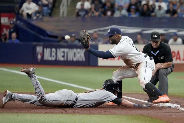Apr 1, 2023; St. Petersburg, Florida, USA; Detroit Tigers third baseman Nick Maton (9) dives back to first as Tampa Bay Rays first baseman Yandy Diaz (2) tries unsuccessfully to make the tag during the third inning at Tropicana Field.