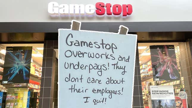 An image shows a hand-written sign about an employee quitting GameStop over a photograph of one of the company's stores. 