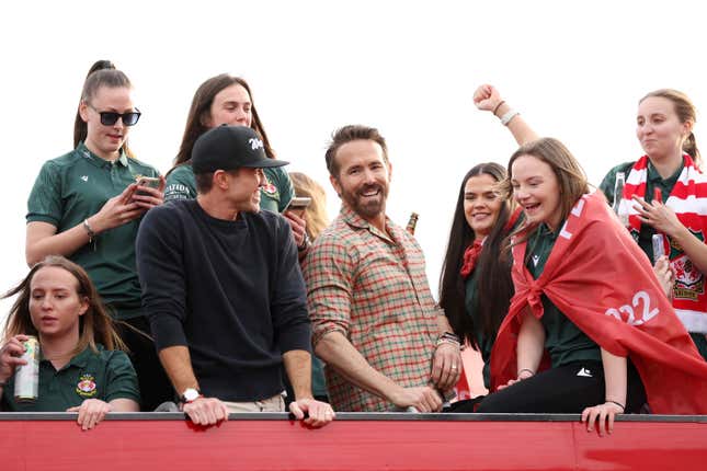 Ryan Reynolds, Co-Owner of Wrexham, and Rob McElhenney, Co-Owner of Wrexham, celebrate with players of Wrexham Men and Women during a Wrexham FC Bus Parade following their respective Title Winning Seasons in the Vanarama National League and Genero Adran North on May 02, 2023 in Wrexham, Wales. (Photo by Jan Kruger/Getty Images)