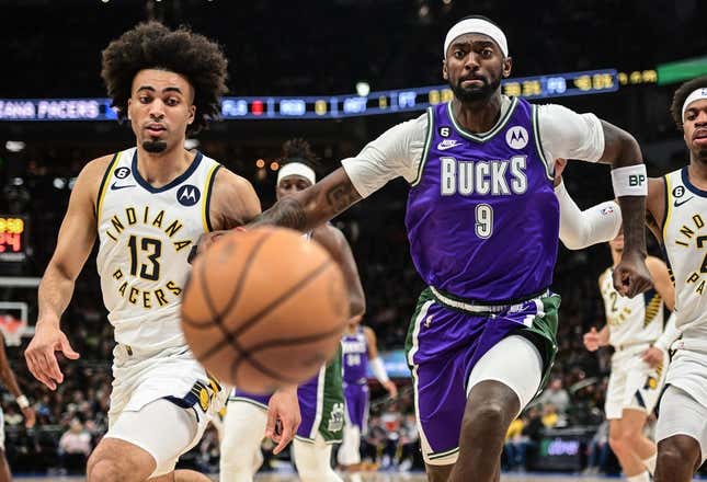 Mar 16, 2023; Milwaukee, Wisconsin, USA; Milwaukee Bucks forward Bobby Portis (9) and Indiana Pacers forward Jordan Nwora (13) chase a loose ball in the first quarter at Fiserv Forum.