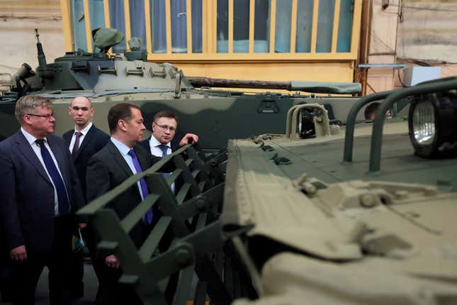 FILE - Deputy head of Russia&#39;s Security Council Dmitry Medvedev, third left, visits the Kurganmashzavod plant known for its BMP series of infantry fighting vehicles, in Kurgan, Russia, Friday, Nov. 11, 2022. Medvedev has said Russia will produce 1,500 battle tanks this year. (Ekaterina Shtukina/Sputnik Pool Photo via AP, File)