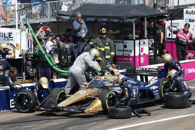 Conor Daly of Ed Carpenter Racing undergoes a pit stop at the 2023 Firestone Grand Prix of St. Petersburg in Florida. Tire changers are replacing his tires with the green compound guayule tire while he also fills up with fuel.