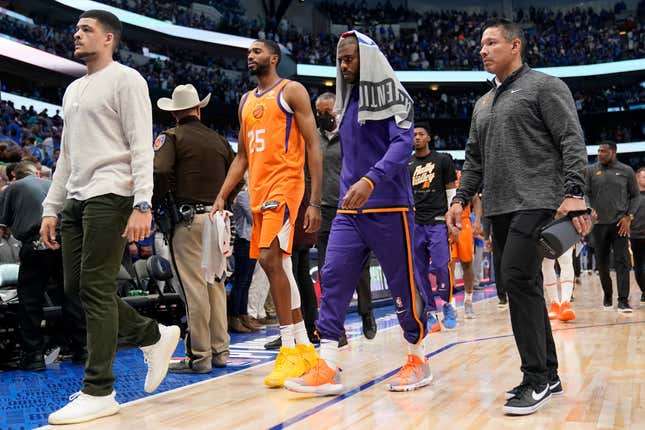 Phoenix Suns forward Mikal Bridges (25) and guard Chris Paul, second from right, walk off the court after Game 4 of an NBA basketball second-round playoff series against the Dallas Mavericks, Sunday, May 8, 2022, in Dallas.
