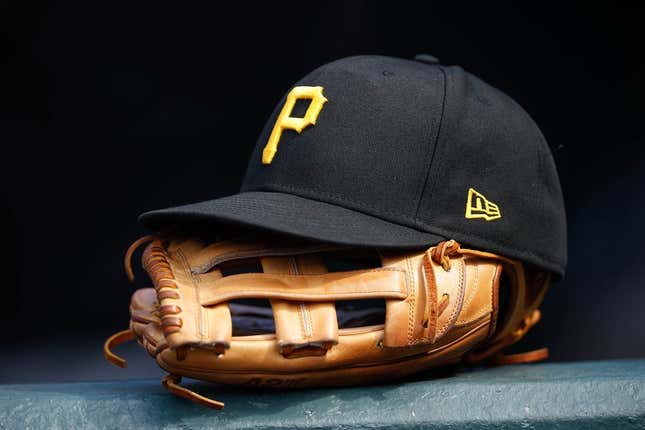 Jun 30, 2021; Denver, Colorado, USA; A general view of a Pittsburgh Pirates glove and hat in the eighth inning against the Colorado Rockies at Coors Field.