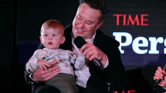 Elon Musk holding an infant