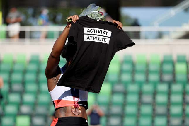 Gwen Berry displays an “Activist Athlete” shirt as she celebrates finishing third in the Women’s Hammer Throw final on day nine of the 2020 U.S. Olympic Track &amp; Field Team Trials at Hayward Field on June 26, 2021 in Eugene, Oregon. 