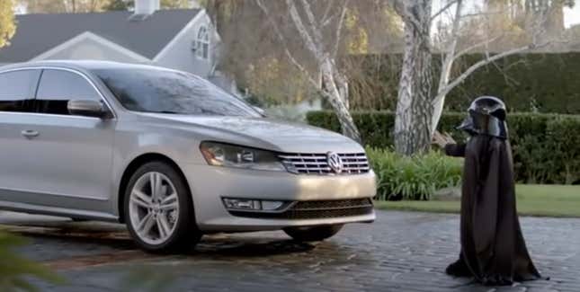 A child dressed as Darth Vader uses his powers on a silver 2012 VW Passat.