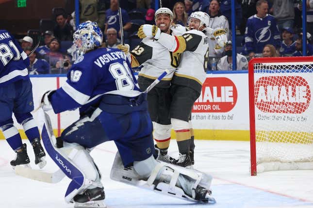 Mar 9, 2023; Tampa, Florida, USA;Vegas Golden Knights defenseman Alec Martinez (23) is congratulated by Vegas Golden Knights right wing Jonathan Marchessault (81) after he scored a goal on Tampa Bay Lightning goaltender Andrei Vasilevskiy (88) during overtime at Amalie Arena.