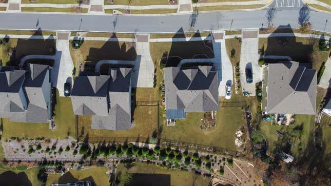 An aerial view of four identical suburban homes 